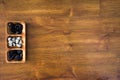 High angle shot of white and black rocks in a wooden plate on a wooden surface Royalty Free Stock Photo