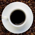 High angle shot of a white cup of black coffee on a surface full of coffee beans Royalty Free Stock Photo