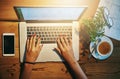 Technology is a must have for modern freelancers. High angle shot of a woman working on a laptop.