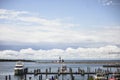 High angle shot of wooden docks with boats on the water under a cloudy sky in Michigan Royalty Free Stock Photo