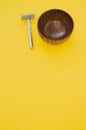 High angle shot of a wooden shaving water bowl near a razor isolated on a yellow background Royalty Free Stock Photo