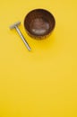 High angle shot of a wooden shaving water bowl near a razor isolated on a yellow background Royalty Free Stock Photo