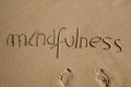 Word mindfulness in the sand Royalty Free Stock Photo