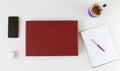 High angle shot of a work desk with a laptop, a cup of coffee, mobile phone, notepad, and headphones Royalty Free Stock Photo