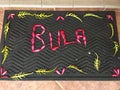 High angle shot of "BULA" text spelled out in flowers in a front door mat in Fiji Royalty Free Stock Photo