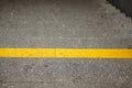 High angle shot of a yellow line painted on the upper step of a staircase Royalty Free Stock Photo