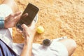 High angle shot of young tennis player taking rest after training and busy in using mobile phone - fitness, Sport and recreation