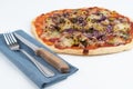 High angle studio shot of freshly baked pizza al tonno isolated on white background. Tuna, olives, onions, veggies Royalty Free Stock Photo