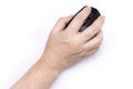A high-angle studio shot of a human hand placed on a sleek black wireless mouse, perfectly isolated on a pure white background for Royalty Free Stock Photo