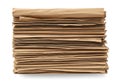 A high angle studio shot of a thick stack of folded brown craft paper sheets isolated against a clean white background Royalty Free Stock Photo