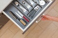 High angle top view cropped photo of woman hand open kitchen drawer by door handle, with different cutlery spoon, pizza Royalty Free Stock Photo