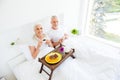 High angle top view cute, sweet, gray hair aged couple drinking