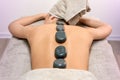 Anonymous woman during hot stone massage Royalty Free Stock Photo