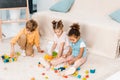 high angle view of adorable multiethnic kids playing with colorful cubes