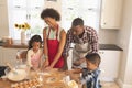 African American family baking cookies in kitchen