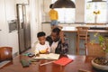 African American father helping his son with homework at table Royalty Free Stock Photo