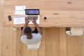 High angle view of african american man sitting at table using laptop working from home Royalty Free Stock Photo