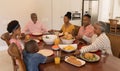 Multi-generation family praying together before having meal Royalty Free Stock Photo