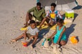 High angle view of african american parents sitting under umbrella while children playing with sand Royalty Free Stock Photo