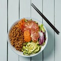 Buddha bowl salad on a pale green table Royalty Free Stock Photo
