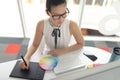 Female graphic designer using graphic tablet at desk in a modern office Royalty Free Stock Photo