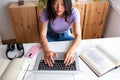 High angle view of Asian young female college student typing on laptop at home office doing homework, studying. Royalty Free Stock Photo