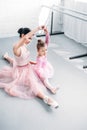 high angle view of ballet teacher and little student training together