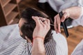 high angle view of barber cutting hair of customer Royalty Free Stock Photo