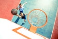 High angle view of basketball player dunking basketball in hoop Royalty Free Stock Photo