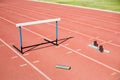 High angle view of baton with track starting block and hurdle on field Royalty Free Stock Photo