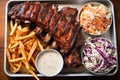 high angle view of bbq ribs, hot fries, and creamy coleslaw on a tray Royalty Free Stock Photo