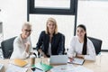 high angle view of beautiful businesswomen looking at camera at meeting