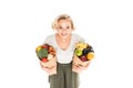 high angle view of beautiful young woman smiling at camera while standing with paper bags full of fresh fruits and vegetables Royalty Free Stock Photo
