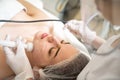 High angle view of beautiful young woman having Radio frequency skin tightening treatment in beauty clinic. Royalty Free Stock Photo