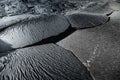 High-angle view of black cracked rocks