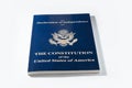 Blue book with declaration of independence and constitution of united states of america on white