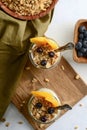 High angle view blueberry and peach granola parfait