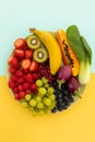 High angle view of bowl of banana, berries, grapes and baby aubergines