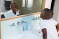 High angle view of boy clenching teeth while looking at mirror Royalty Free Stock Photo