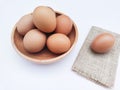 High angle view of broiler chicken eggs in a bowl on a white background.