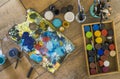 High angle view of brushes, pallete, oils, acrylics and other elements of a painter artist. Art workshop. Background