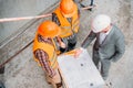 high angle view of builders and architect discussing blueprint Royalty Free Stock Photo