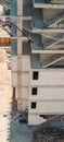 High angle view of a building under construction with unfinished concrete staircases and construction site safety net