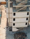 High angle view of a building under construction with unfinished concrete staircases and construction site safety net