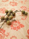 High angle view of a bunch of Longan Dimocarpus longan on red background.