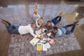 High angle view of business people lying on carpet while working in creative office Royalty Free Stock Photo