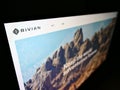 High angle view of business website with logo of American electric vehicle company Rivian Automotive LLC on monitor.