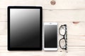 High angle view of businessman desk with cell phone and tablet,smartphone, glasses and clock. Royalty Free Stock Photo