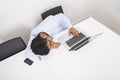 High angle view of businessman sleeping by laptop at desk in office Royalty Free Stock Photo