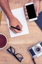 High angle view of businessman writing on notepad Royalty Free Stock Photo